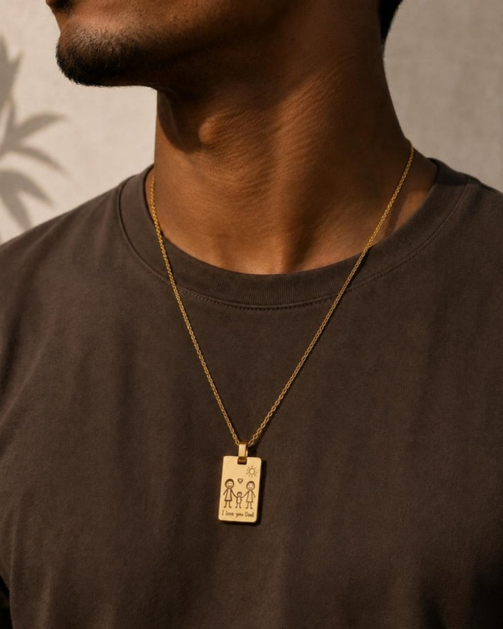 Man wearing gold Frame Pendant engraved with a child's drawing