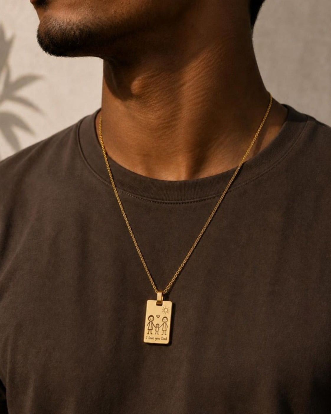 Man wearing gold Frame Pendant engraved with a child's drawing